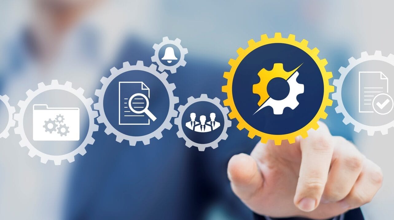 A hand touching a glowing gear icon among connected icons for documents, workflows and teams.